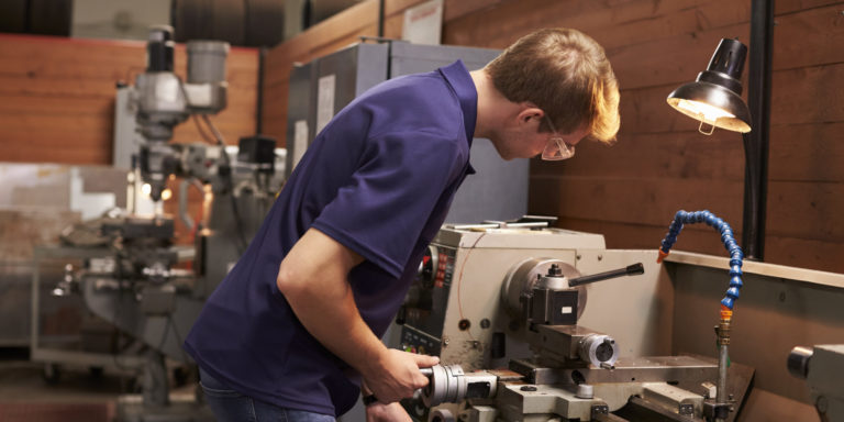 Male Engineer In Factory Using Milling Machine