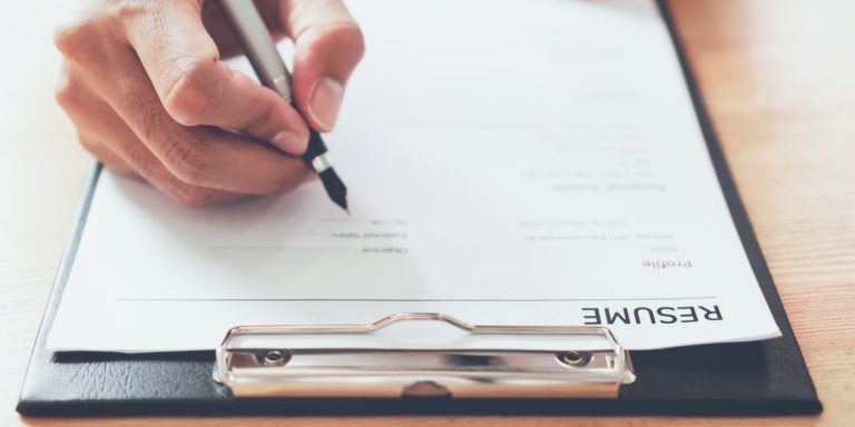 man submit resume to employer to review job application. The concept presents the ability for the company to agree with the position of the job.